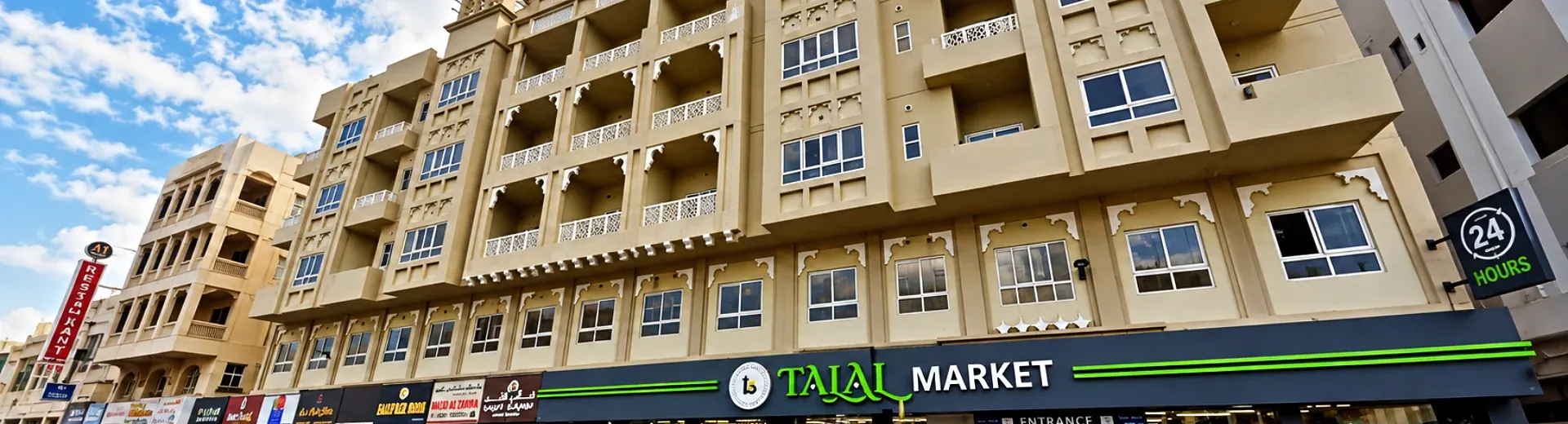 Busy street of commercial buildings with retail shopfronts and signage